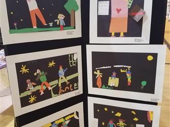 Student art panel of six paper-stripped created pictures depicting several scenes: A teacher in a classroom, a father and son on a field in the evening, a band trio performing on stage, a landscape scene of a house and windmill, a two person group performing on a stage, and a picture of three figures.